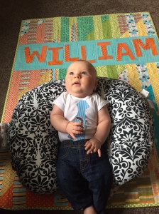 William celebrating his three month birthday on his quilt.